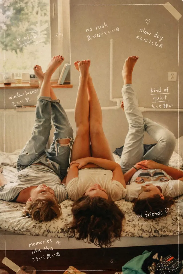 Three friends lying on a bed with their legs up the wall in warm film tones, framed like a diary page with notes such as “no rush”, “slow day” and “memories like this” in English and Japanese